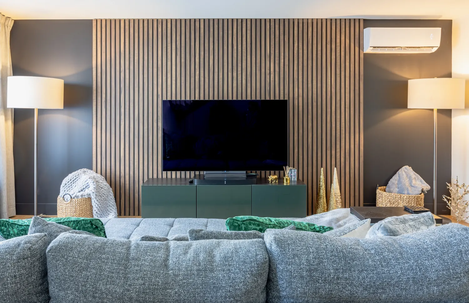 A Halifax living space where existing seating is paired with a new slatted-wood feature wall, styled by MAD Design Interiors